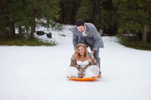 Wedding couple sledding on the Wawona golf course