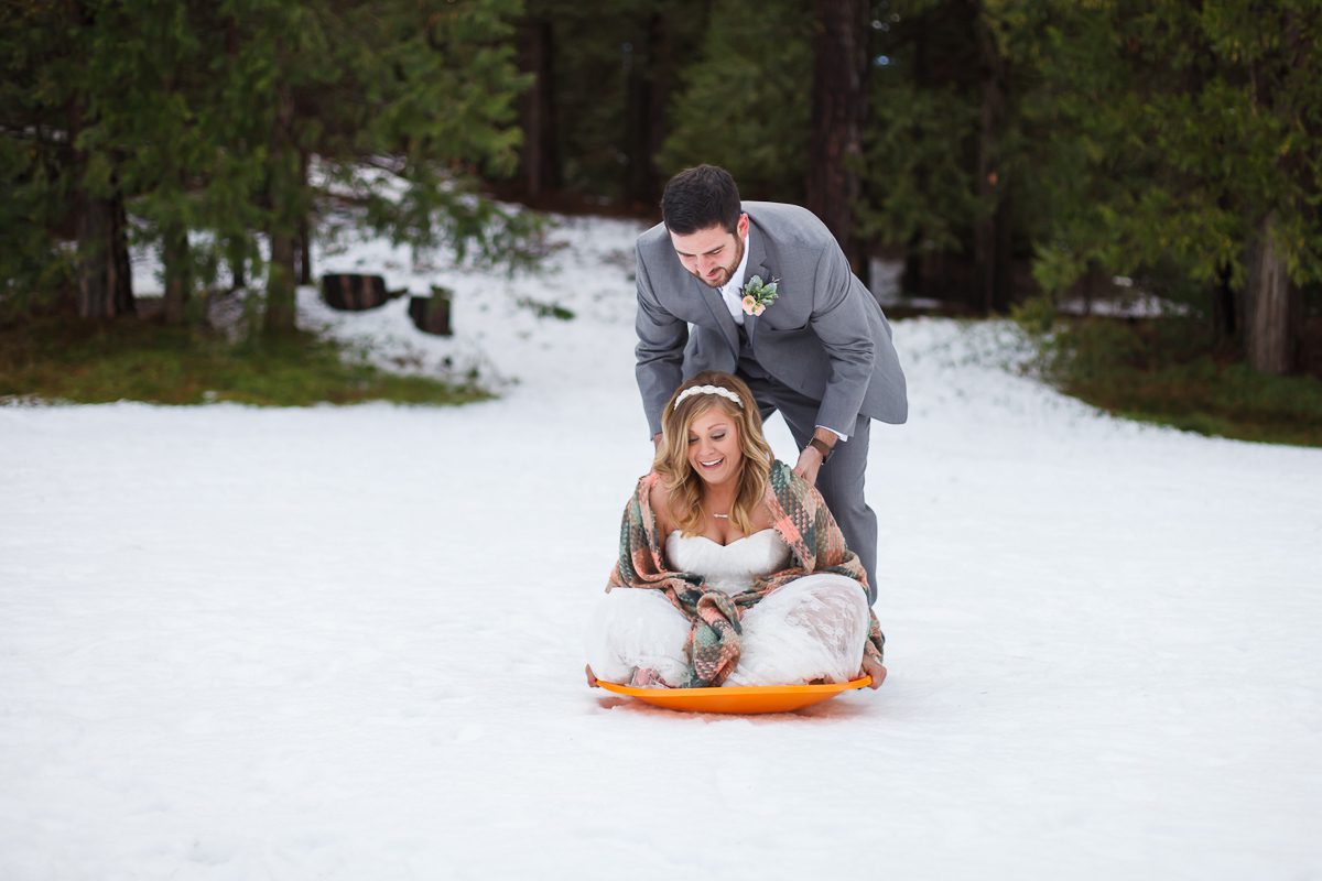 bride and groom sledding in Wawona